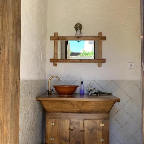 a bathroom with a wooden sink and a mirror at El Corral de Tía Gloria in Pepino