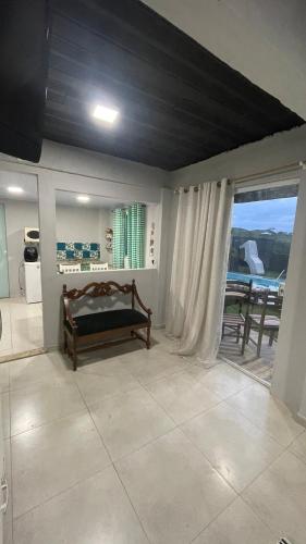 a bedroom with a bed and a balcony with a table at Loft das Maritacas - Conservatória in Valença