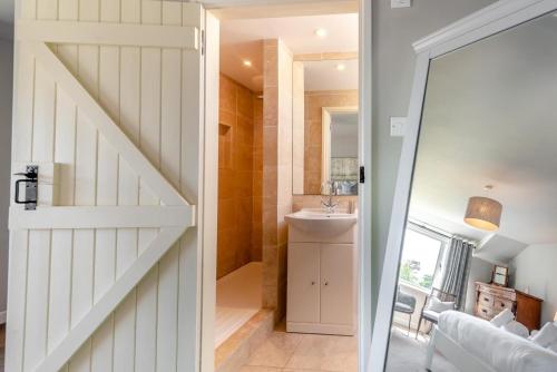 a bathroom with a sliding door leading to a sink at 2 Bed in St. Brides oc-s30491 in Saint Brides