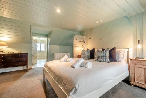 a large bedroom with a large white bed with pillows at 2 Bed in St. Brides oc-k30489 in Saint Brides