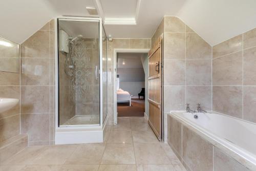a bathroom with a shower and a tub and a sink at 2 Bed in St. Brides oc-k30489 in Saint Brides