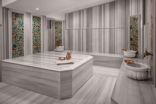a bathroom with a large tub and a sink at Ceylan Splend'or Uludag, Autograph Collection in Uludar