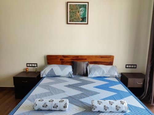a bedroom with a bed with two pillows on it at Chitrangan The Homestay of Udaipur in Udaipur