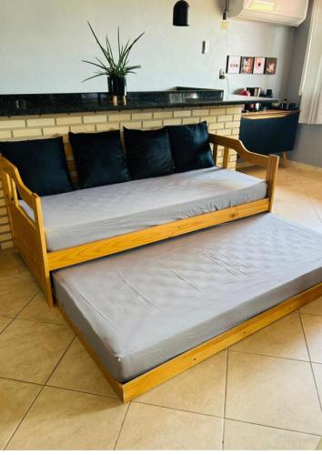 two beds sitting on the floor in a room at Studio com piscina e garagem Conforto e fácil acesso BR-101-Petfriendly, 2º andar in Joinville