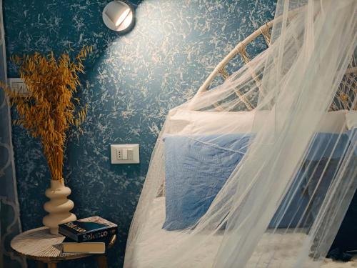 a bedroom with a bed with a mosquito net at B&B Zio Cici in Minervino di Lecce