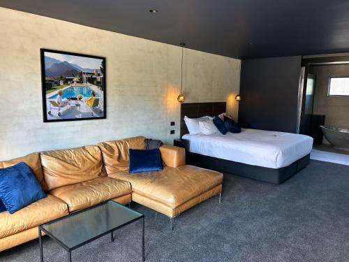 a hotel room with a couch and a bed at 187 Heathcote in Heathcote