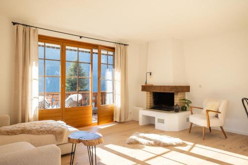 a living room with a couch and a fireplace at Chalet Valentina in Chateau-d'Oex