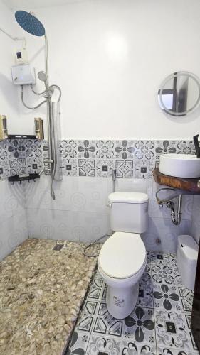 a bathroom with a toilet and a sink at SilverLeaf in El Nido