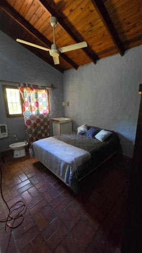 a bedroom with a bed and a ceiling fan at Casa Refugio in Paso de la Patria