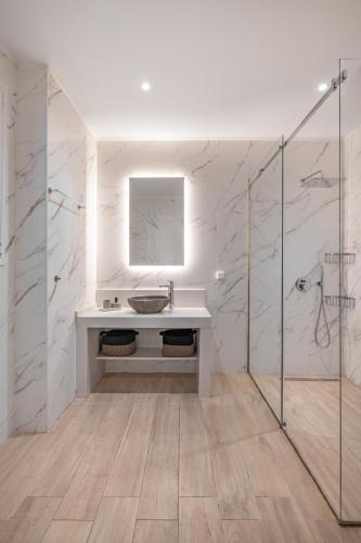 a white bathroom with a sink and a shower at Rhodes center Santa Mari in Rhodes Town