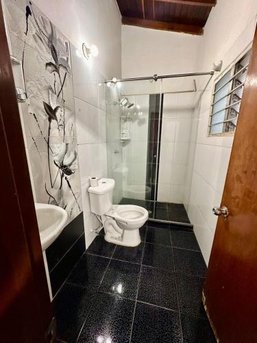 a bathroom with a toilet and a sink at Hostel Urban City Medellin in Medellín