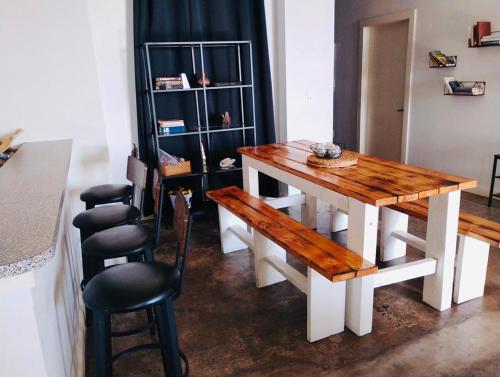 a dining room with a wooden table and chairs at The Downtown Stadium Loft in Memphis