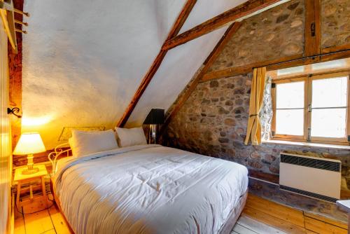 a bedroom with a bed and a window at Maison Bilodeau Ethier - 5 chambres - 13 personnes in Saint-Férréol-les-Neiges