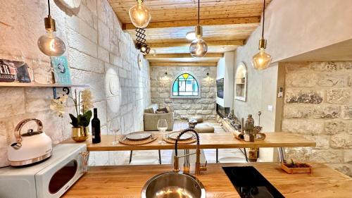 a kitchen with a sink and a counter with a microwave at Bankers 1880 The Turkish Quarter hotel in Haifa