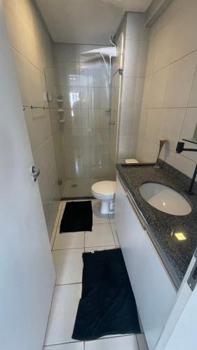 a bathroom with a sink and a shower and a toilet at Flat Jardins Madalena in Recife