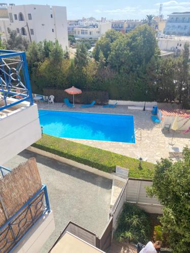 a view of a swimming pool from a building at Newly Renovated Light House Beach 8 min in Paphos