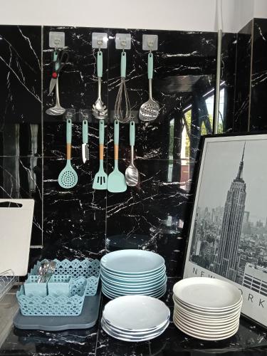 a table with plates and utensils on a counter at Loft Life Pool villa in Ban Huai Yai