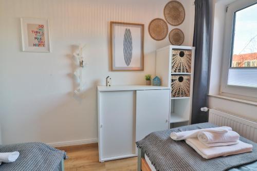 a bathroom with a sink and a counter with towels at Blüten & Meer - Haus Meer in Langeoog