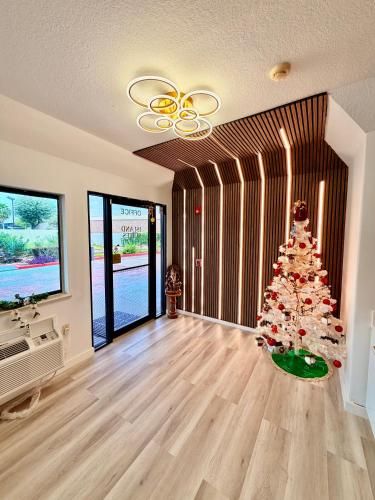 a christmas tree in the middle of a living room at Island Suites Hobby Airport in Houston