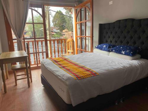 a bedroom with a large bed and a balcony at Attic Hotel in Chachapoyas