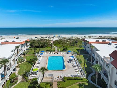 an aerial view of a resort with a swimming pool and the beach at Spanish Trace 235 in St. Augustine