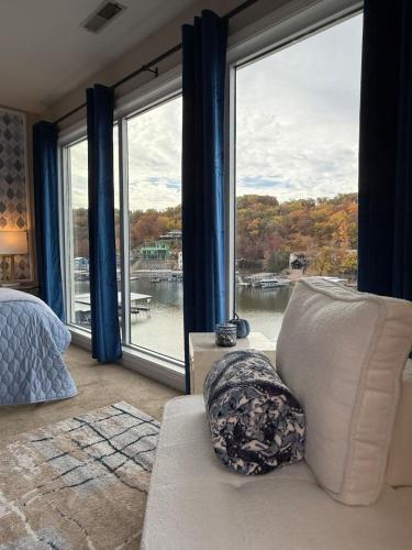 a bedroom with a large window with a view of the water at Lakefront Condo Private Deck 3 Pools in Osage Beach