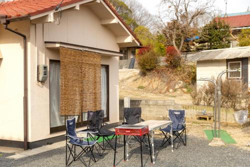 a patio with a table and chairs in front of a house at inn 1st in Yakage