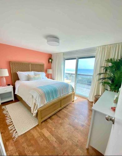 a bedroom with a bed with a view of the ocean at Nautical Endeavors Beach House Steps from Surf in Rodanthe