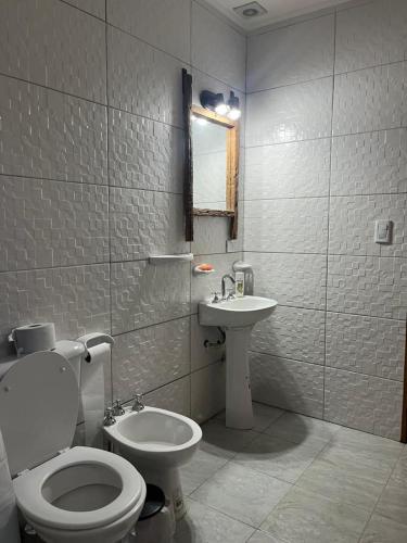 a bathroom with a toilet and a sink at La Matera de Hugo in Lobos