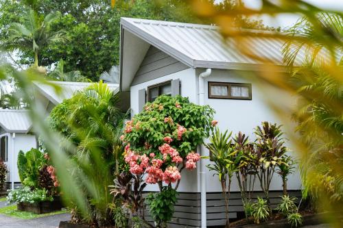 a white house with flowers in front of it at Tasman Holiday Parks - Cairns Cool Waters in Cairns
