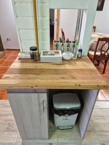 a wooden desk with a trash can in a room at Departamentos H&G in Punta Arenas