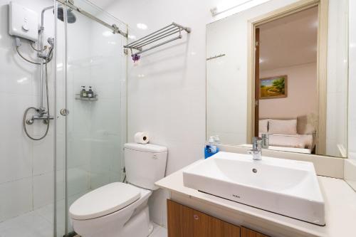 a bathroom with a toilet and a sink and a shower at Jade House Tran Cao Van in Ho Chi Minh City