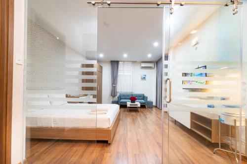 a bedroom with a bed and a glass wall at Jade House Tran Cao Van in Ho Chi Minh City