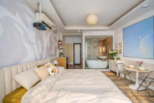 a bedroom with a large bed and a bathroom at Aimee House Vũ Miên in Hanoi