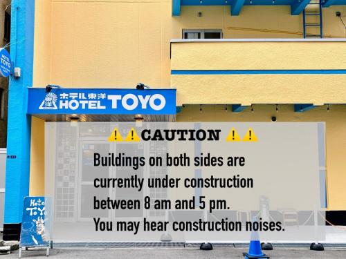 a sign in front of a hotel at Backpackers Hotel Toyo in Osaka