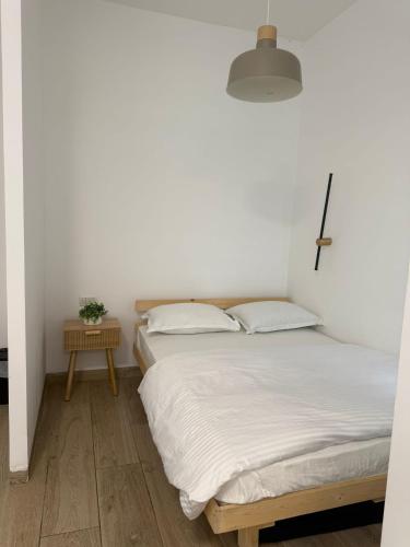 a bedroom with two beds and a cross on the wall at יחידת אירוח אור בזלת in Qiryat Shemona