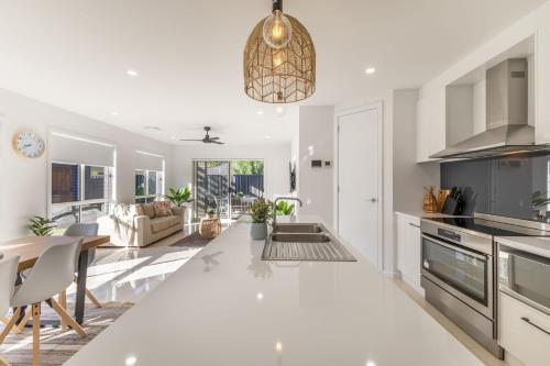 a kitchen and living room with a table and chairs at Lavender & Olive in Myrtleford