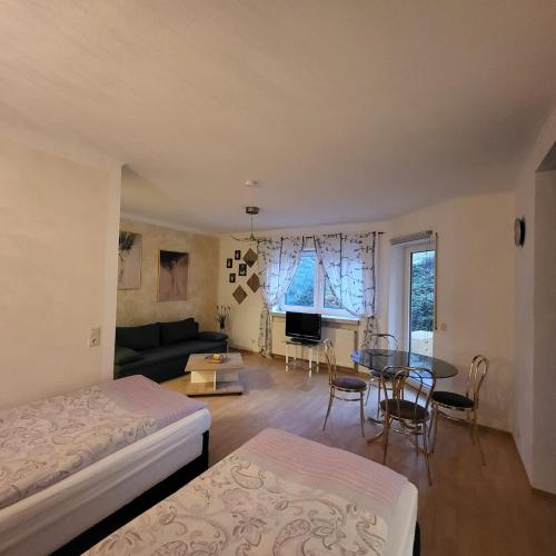 a room with a bed and a table and a couch at Apartment Weimar II in Ulla