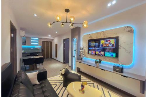 a living room with a couch and a flat screen tv at CSJ Tower Seaview Apartment -Luxury Near Back Beach Vung Tau City in Vung Tau
