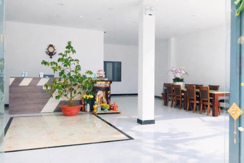 a living room with a table and a dining room at HT Hotel in Xuyên Mộc