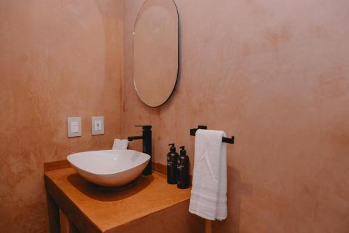 a bathroom with a sink and a mirror on a counter at Hotel Boutique Casa Yága in Querétaro