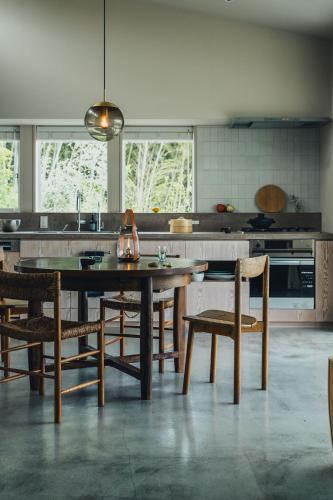 a kitchen with a table and some chairs in it at SANU 2nd Home CURRENT Awajishima in Awaji