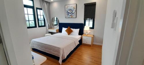 a bedroom with a bed and a mirror in it at Villa NovawoRld Phan Thiết in Bình Sum