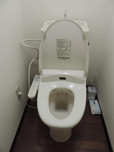 a bathroom with a toilet with a remote control at フレクション大工町 in Miyazaki