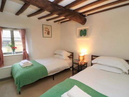 a bedroom with two beds and a window at Burford Apple in Burford