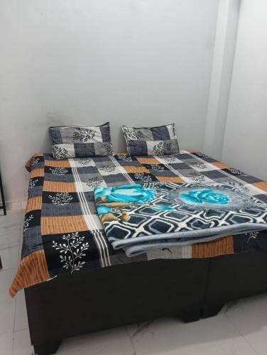 a bed with two pillows and a blanket on it at Independent homestay DDN in Dehradun