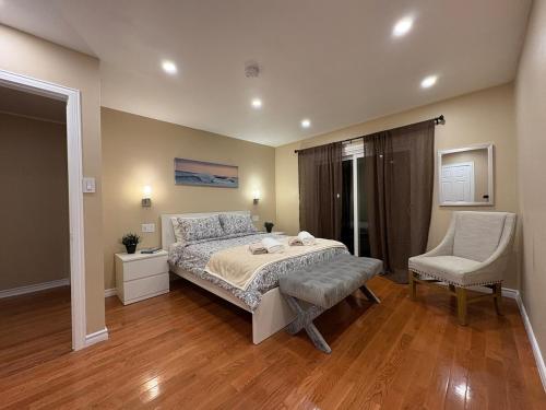 a bedroom with a bed and a chair in it at Tamuna's Home in Hamilton