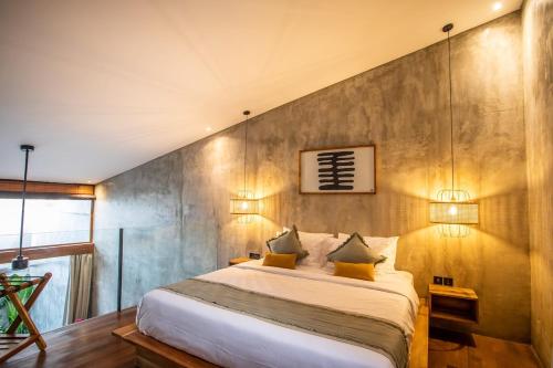 a bedroom with a large bed with two lamps at The Echo Studios HUGE 100m to beach 1 in Badung