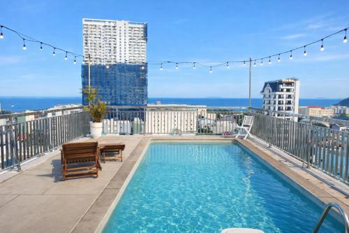 a swimming pool on the roof of a building at Mira Grand Hotel Quy Nhơn in Quy Nhon