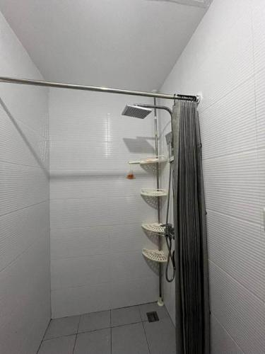 a shower with a shower curtain in a bathroom at Bernwood Tower IloIlo - Heavens Crib in Iloilo City